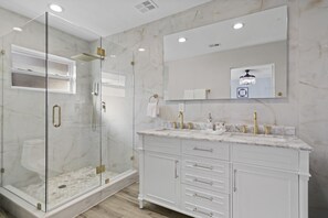 Bathtub, hair dryer, towels, toilet paper