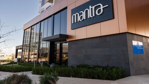 A modern building with a large glass facade, a prominent 'mantra' sign, and a 'FIRE' emergency exit sign. - Mantra Tonsley Adelaide (Tonsley)