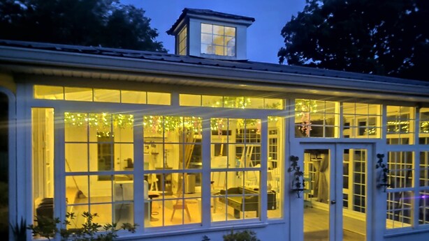 A building with large windows and a door, surrounded by greenery. - The Ole Pole Barn at Dry Creek Hideaways (Middle Valley)