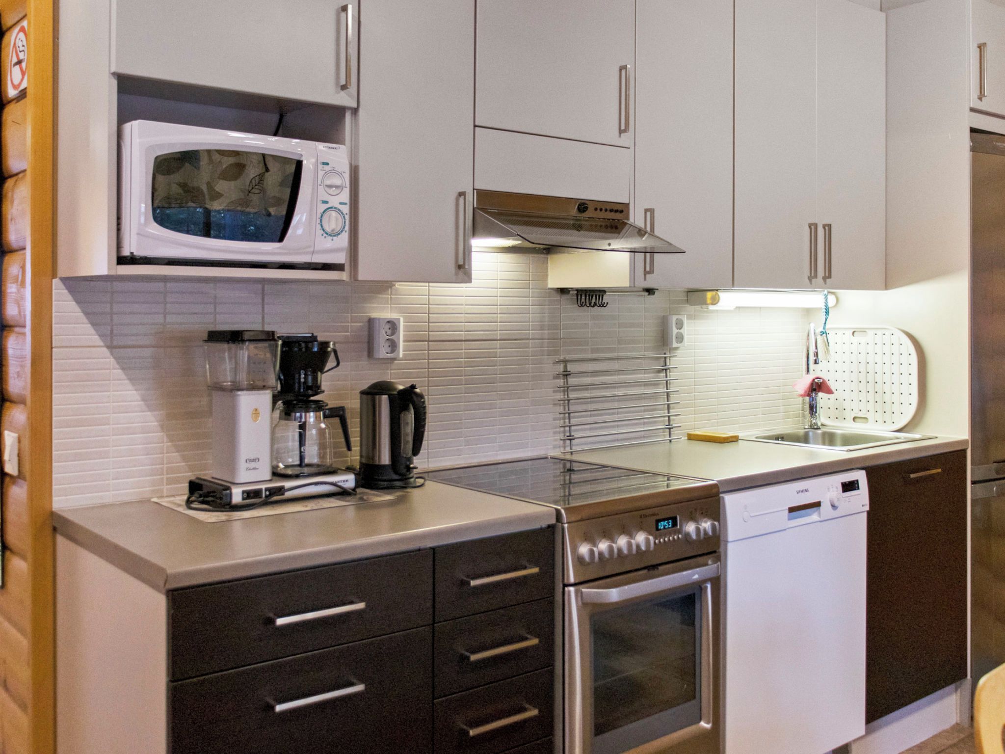 A modern kitchen with a microwave, coffee maker, and dishwasher.
