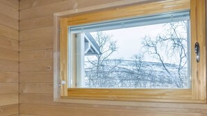 A wooden cabin interior with a window revealing a snowy landscape and bare trees outside. - Willa kiiruna by Interhome (Enontekiö)