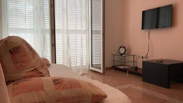 Apartment (One Bedroom Apartment with Terrace an) | Living room | 25-inch flat-screen TV with satellite channels, TV