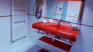 A bathroom with a red sink, white tiles, a towel rack, and a mirror. - San Lazzaro 81 Mansarda (Andora)