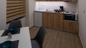 Eine kleine Küche mit Holzausstattung, einer Mikrowelle und einem Spülbecken.