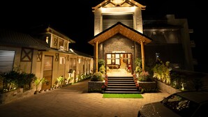 A two-story building with a prominent entrance, a staircase leading to the main door, and a well-lit facade. - WelcomHeritage Parv Vilas Resort & Spa (Solan)