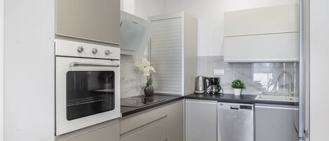 Apartment | Private kitchen | Cleaning supplies, freezer, paper towels, dining tables