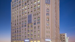 A multi-story hotel with a classic architectural design, featuring balconies and large windows. - Central Inn Souq Waqif (Doha)