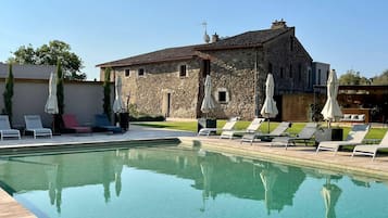Seasonal outdoor pool, open 10:00 AM to 8:00 PM, pool umbrellas