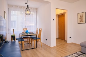 Relax in a spacious living room with a dining area, flat-screen TV, and comfortable seating.