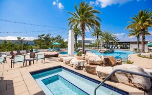 Relax by the pool surrounded by palm trees and lounge under shaded umbrellas.
