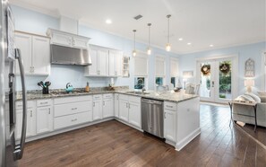Enjoy cooking in this well-equipped kitchen with a large island, sink, and dishwasher.