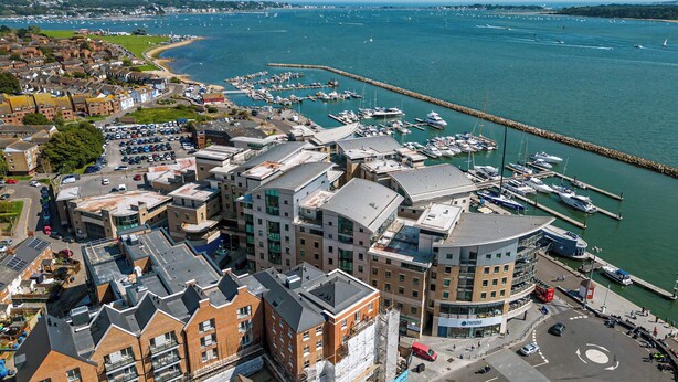 A coastal town with a marina, modern buildings, and a roundabout. - Once Upon a Tide - Apartment in the Heart of Poole (Poole)