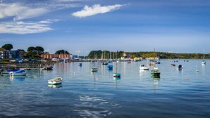 A marina with various boats docked, calm water, and buildings in the background. - Once Upon a Tide - Apartment in the Heart of Poole (Poole)