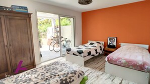 A bedroom with a bed, a wardrobe, and a bicycle in the background. - Beautiful architect-designed villa 30 m from the beach ☀️ (Andernos-les-Bains)