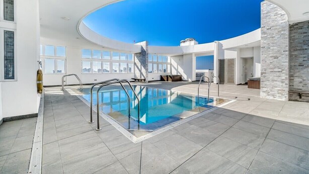 An indoor swimming pool with a skylight, a staircase, and a brick wall. - Wood Summer 2B W/Parking, Wifi & View. (Viña del Mar)