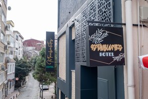A street view with a building featuring a sign for "St. Barbara Hotel".