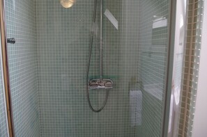 A shower with a glass door, a handheld showerhead, and a handheld shower attachment. - Country Hideaways | The Hay Loft | Ripon (Ripon)