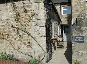 A stone cottage with a sign reading 'Forge Cottage.' - Country Hideaways | Forge Cottage | Masham (Ripon)