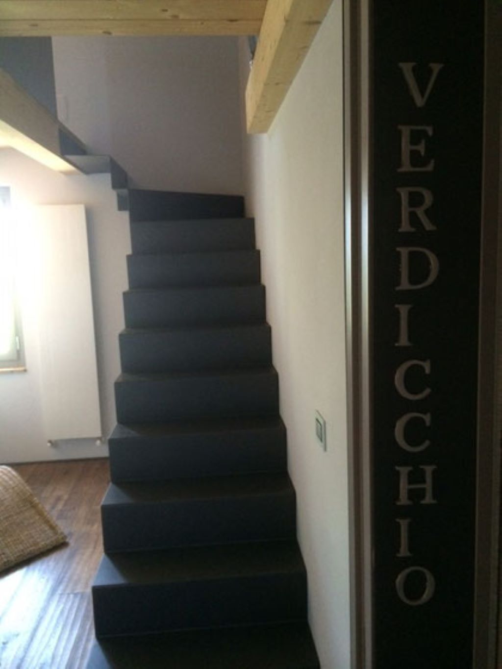 A staircase with a sign reading "VERDICCHIO".