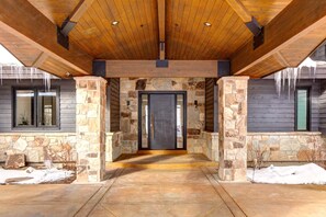A covered entrance with stone pillars, a wooden ceiling, and a door leading inside. - Park City | KBM Resorts | Indoor Pool,Home Theater, Playground | Single Unit, 6 Bedrooms |  ML-618 (Park City)