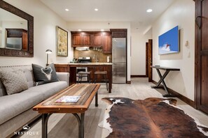 TV, fireplace, books - The Lodge at Mountain Village | Gorgeous Ski-In/Ski-Out Condo | A Nestique Property (Park City)