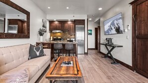 A modern kitchen with wooden cabinets, a central island, and a dining area with a wooden table.