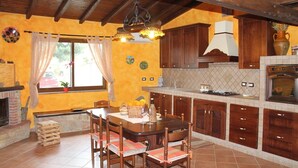 A kitchen with wooden cabinets, a tiled backsplash, and a built-in oven.