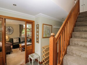 A staircase with a wooden handrail leading to a landing. - Middlerigg (Windermere)