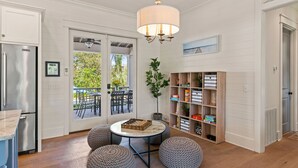 A kitchen with a marble countertop, a chandelier, and a view of the outdoors. - Stollaway Retreat - 5 Bedrooms with Pool (St Simons Island)