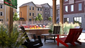An outdoor seating area with chairs and a fire pit, surrounded by greenery and buildings in the background. - Magnificent 4BR House in Bloomington with Hot Tub (Bloomington)