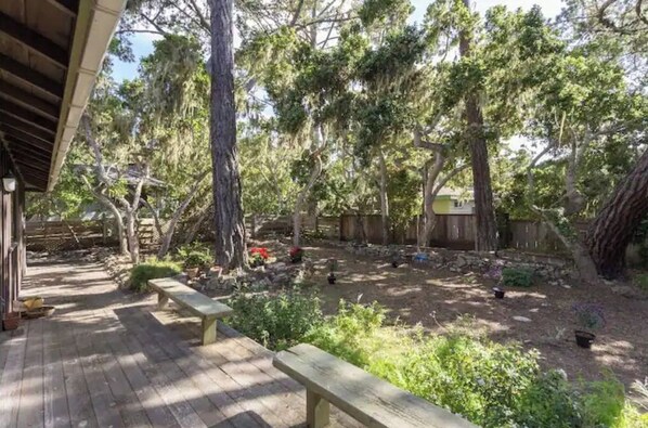 Step out onto the deck and enjoy the serene surroundings amidst mature trees and lush greenery.