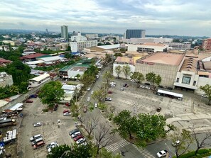 An aerial view of a cityscape with various buildings, roads, and vehicles. - The Loop Condotel (Cagayan de Oro)