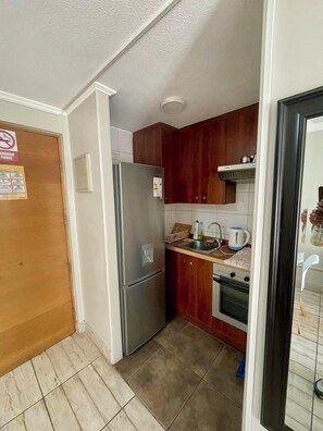 Standard Apartment, 1 Bedroom | Private kitchen | Full-size fridge, oven, electric kettle, cookware/dishes/utensils - AcuñayDonoso ApartamentosCentro  (Santiago)