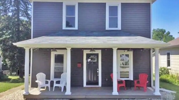 A two-story house with a covered porch and two doors. - 3BR Newly Renovated House in the heart of Sturgeon Bay (Sturgeon Bay)