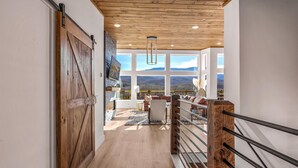 Un interior de madera con vistas a las montañas a través de amplios ventanales.