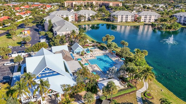 A resort with multiple swimming pools, a large building labeled "The Twisted Tuna," and a lake with a fountain. - Beach Access Resort Condo with Breath-Taking View (Jupiter)