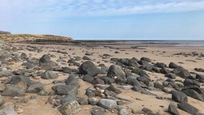 A rocky beach with a clear sky. - 2 bedroom accommodation in Hadston, near Amble (Hadston, near Amble)