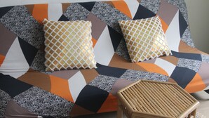 A sofa with a geometric patterned fabric and two patterned cushions. - 1 Studio Flat walking distance to ski lifts (we have 2 in the same building) (Kaprun)