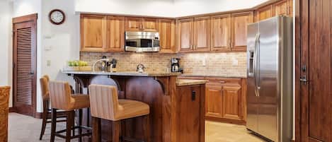 Enjoy cooking in this well-equipped kitchen with a microwave, refrigerator, and sink.