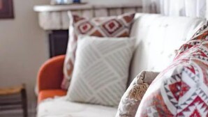 A bed with patterned bedding and a bedside table. - Kalivia House - Entire Home (Skoutari)