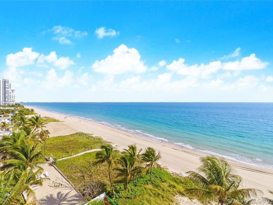On the beach, white sand, sun-loungers, beach umbrellas