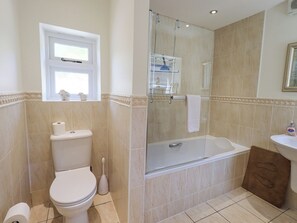 A bathroom with a toilet, bidet, shower, and sink.