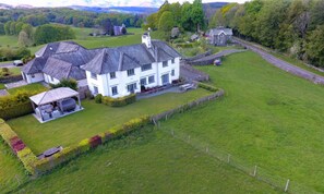 A large white house with a spacious lawn and a covered outdoor seating area. - Hawkrigg Farm (Ambleside)