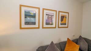 Three framed posters on a wall, each depicting a different location: Catbells, Derwentwater, and Helvellyn. - Bowderstone (Keswick)