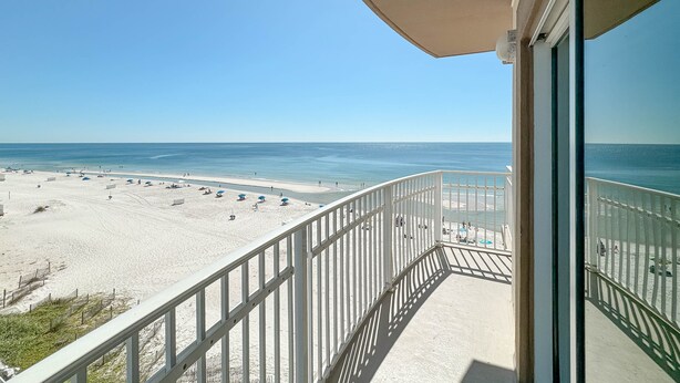 A balcony with a view of a beach and ocean. - Crystal Shores West 101- Enjoy the View of Paradise (Gulf Shores)
