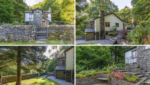 A stone house with a stone staircase, surrounded by lush greenery. - Brooklands (Ambleside)