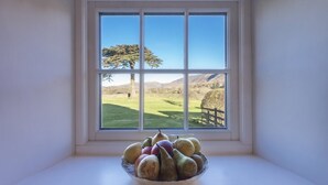 A window with a view of a rural landscape, including a tree and a fence. - Cedar Nook (Cockermouth)