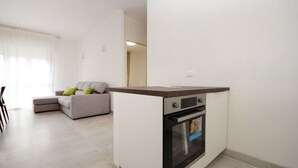 A modern kitchen with a built-in oven and a small countertop.