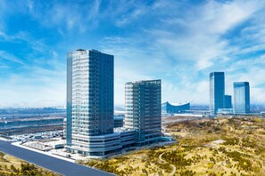 A modern high-rise building complex with multiple skyscrapers, surrounded by a landscaped area with pathways and greenery. - Shanxi Xiaohe Xincheng Talent Apartment (Taiyuan)