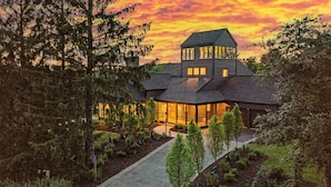 A large, multi-story house with a well-maintained garden and a paved driveway. - Tower House | Heated Pool, Sauna, Hot Tub + Views (Galena)